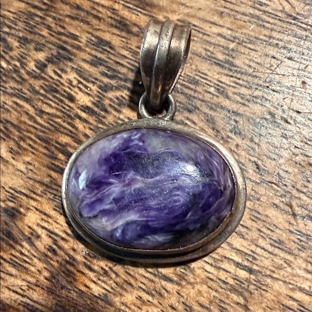 This is a vintage charoite pendant with a sterling silver bail Purple Stone